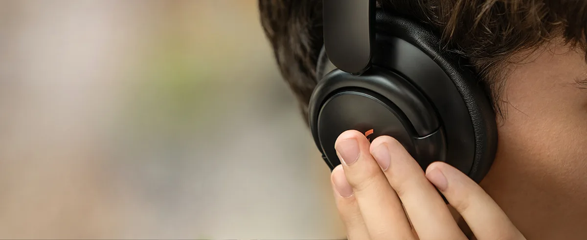 Person wearing Anker Soundcore Q30 showing earcup touch controls