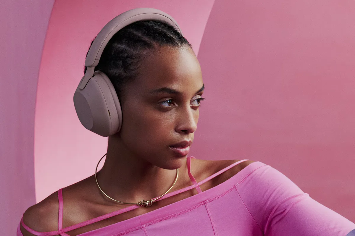 Woman wearing Sony WH-1000XM5 headphones in lifestyle portrait